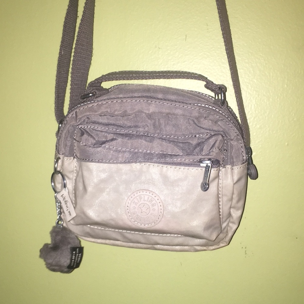 Ivory and light gray adjustable Kipling bag